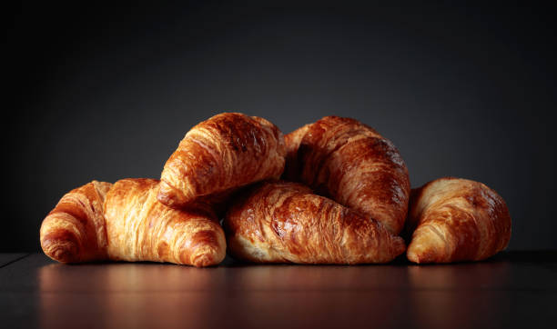 istock Freshly baked croissants on a black ceramic table. 1601073238