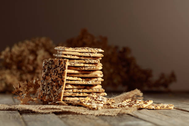 istock Crackers with sunflower and flax seeds on an old wooden table. 1601074164