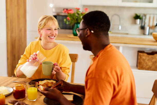 istock Multiracial couple enjoying breakfast together at home 1601074376