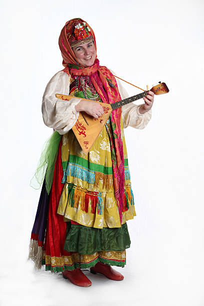 Woman in Russian costume playing instrument stock photo