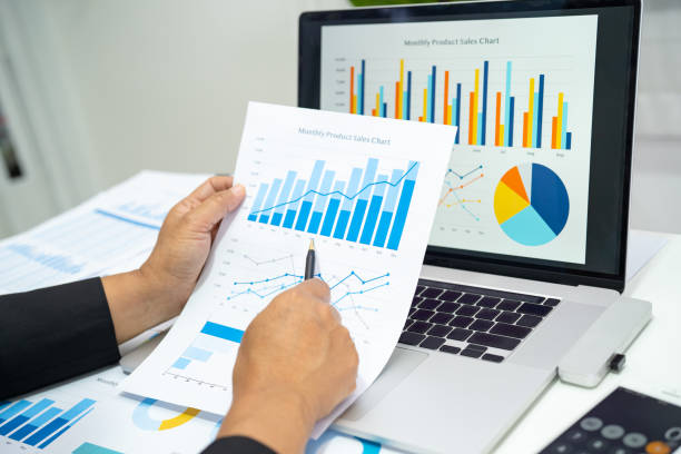 istock Asian accountant working and analyzing financial reports project accounting with chart graph in modern office, finance and business concept. 1601079756