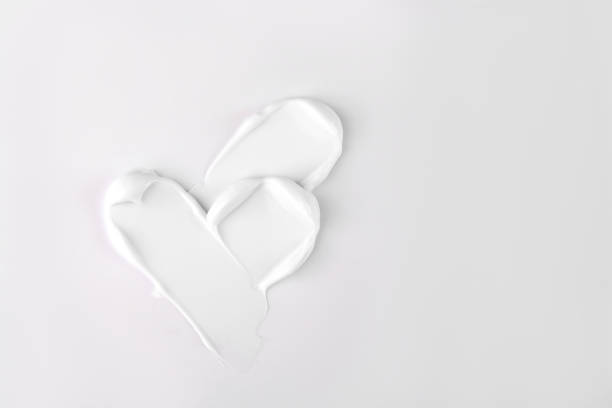 White cosmetic face cream or body lotion moisturizer stroke on white background. Hygiene, skincare product with creamy texture. Beauty face creme smear swatch on color background