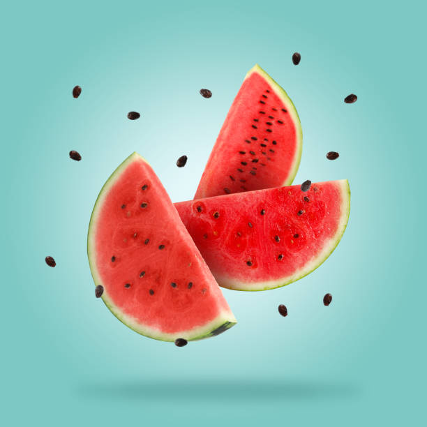 istock Slices of fresh juicy watermelon falling on light blue background 1601087071