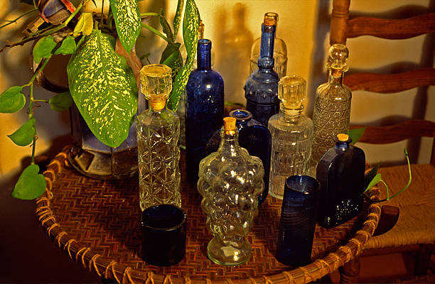 Coloured glasses bottles on a tray stock photo