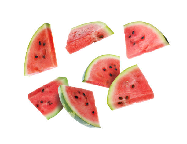 istock Slices of fresh juicy watermelon falling on white background 1601097481