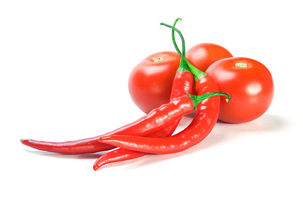 Red chilly peppers  and tomatoes stock photo