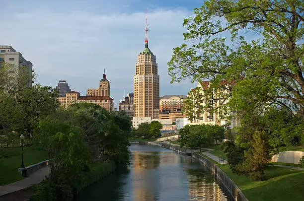 The sun sets on downtown San Antonio, Texas in this postcard-like view from the Riverwalk.