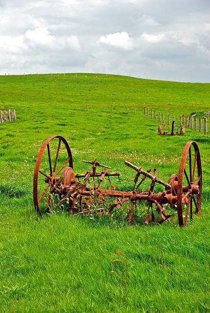 istock Farm equipment rusts in a field of green 160110174
