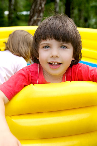 istock little cute smiling girl in rubber trampoline 160110425