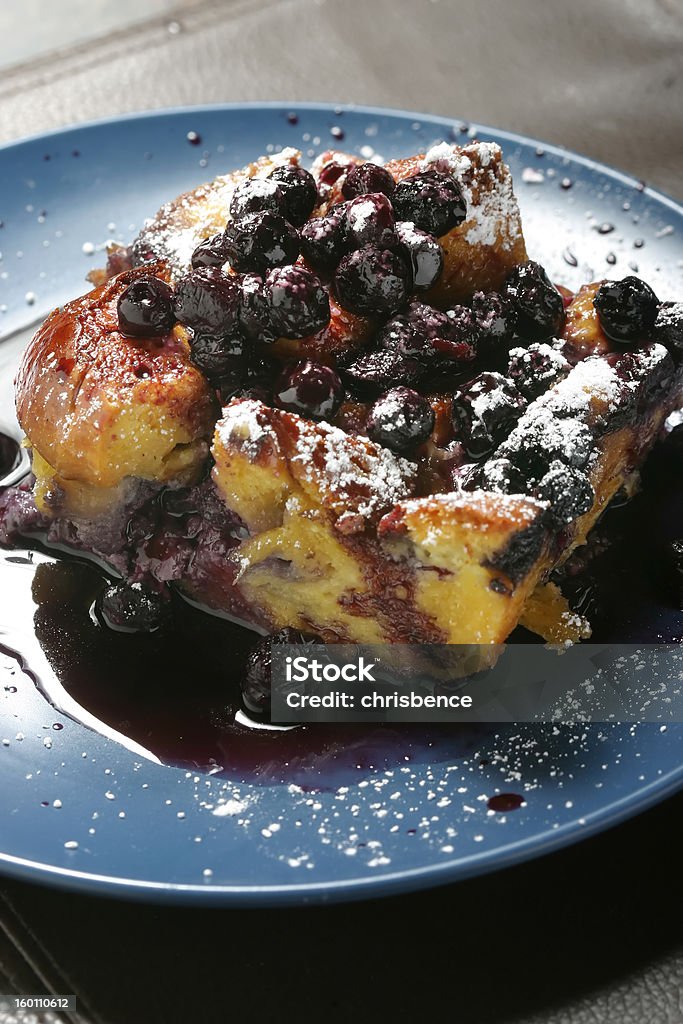 Blueberry Delight Blueberry bread pudding on a dessert plate. Berry Fruit Stock Photo