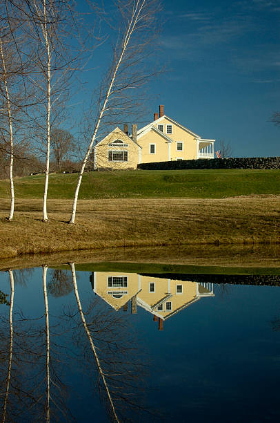 Reflected Farmhouse in a pond stock photo