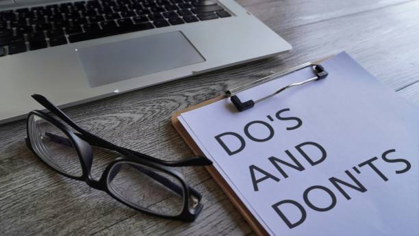 istock Laptop, glasses and paper clipboard with text DO'S AND DON'TS 1601111269