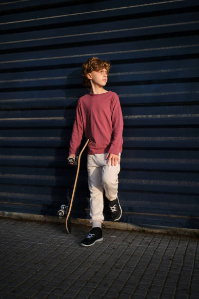 istock Little skater resting near wall 1601112780