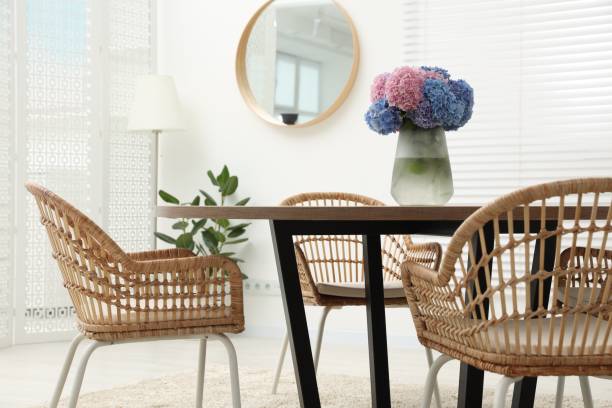 istock Vase with hydrangea flowers on wooden table in stylish dining room 1601119036