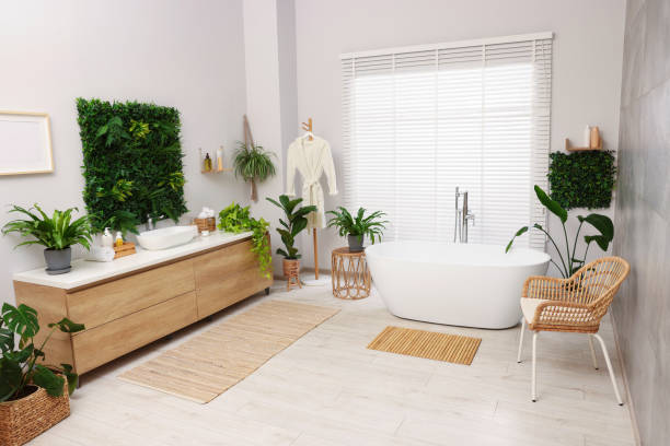 istock Green artificial plants, vanity and tub in bathroom 1601119039