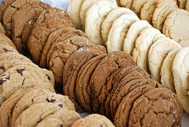 Baked Goods Various kinds of cookies arranged in a row. biscuit stock pictures, royalty-free photos & images