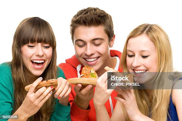 Three Young Friends Eating Pizza Stock Photo - Download Image Now - Eating, Friendship, Pizza