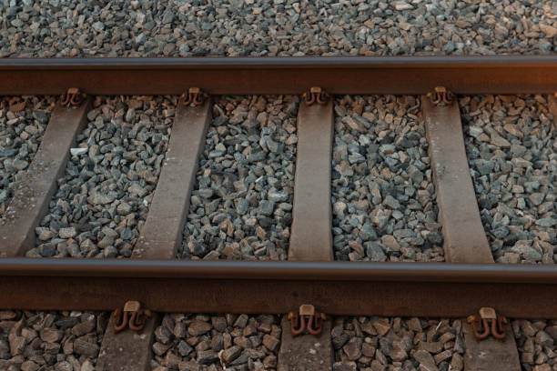 istock Close up of rusty trail railway on granite base. 1601132054