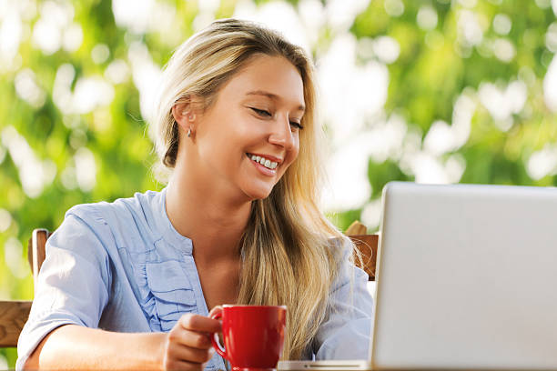 istock Blonde woman with laptop 160113309