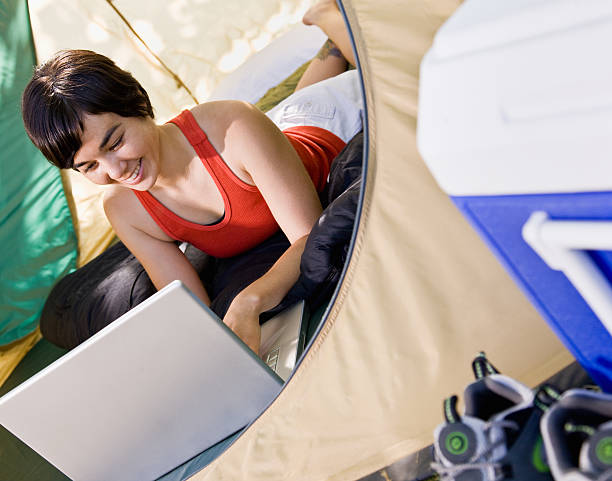 istock Woman using laptop in tent 160113439