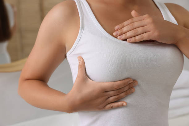 istock Woman doing breast self-examination in bathroom, closeup 1601136518