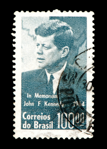 The Kennedy half dollar 50 cent coin issued by the United States Mint year 1996 as a memorial to the assassinated 35th president of the United States John F. Kennedy, selective focus of 1996 D 50C MS, selective focus of the coin isolated on wooden background