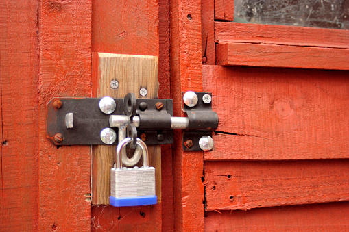 Close-up of a padlock and bolt on a garden shed. A picture of the shed itself can be seen here: http://www.istockphoto.com/file_thumbview_approve.php?size=2&id=875464