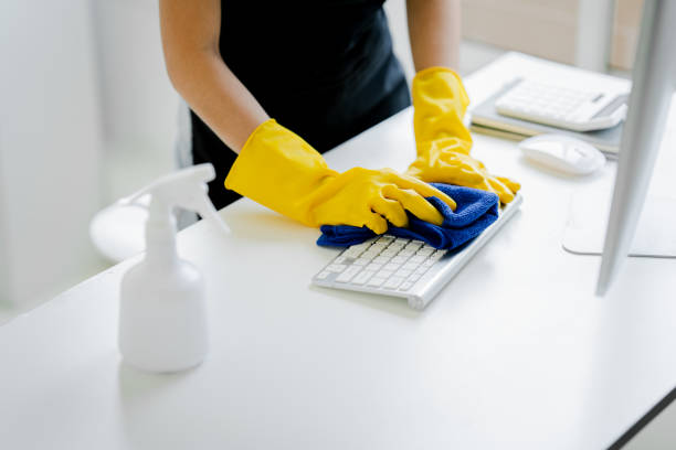 istock Young woman using a computer keyboard cleaning cloth to disinfect the officeoffice cleaning staff cleaning maid 1601153513