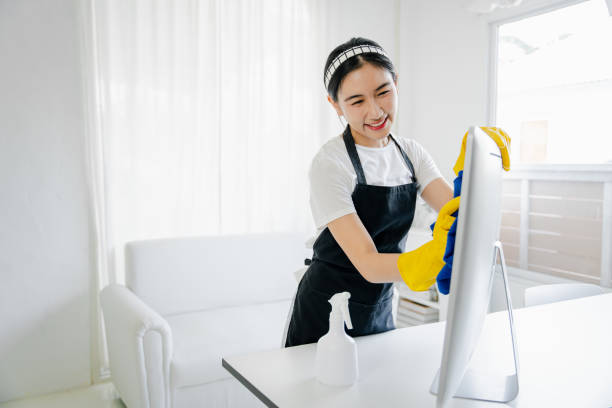 istock Young woman using a computer cleaning cloth to disinfect the officeoffice cleaning staff cleaning maid 1601154652