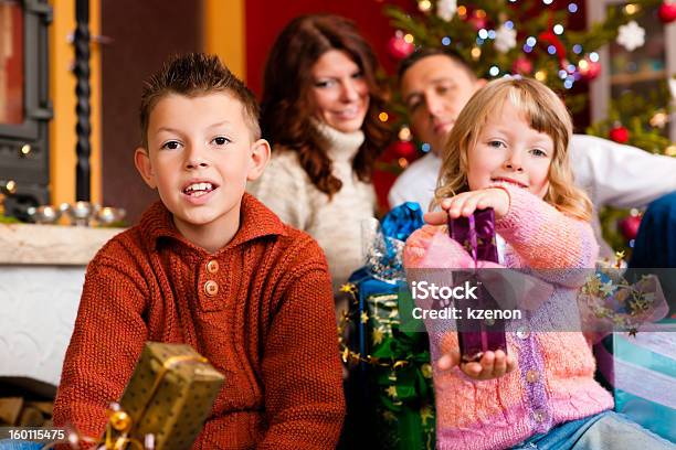 Christmas Family With Gifts On Xmas Eve Stock Photo - Download Image Now - Adult, Boys, Brother