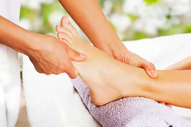 Foot massage in the spa salon in the garden