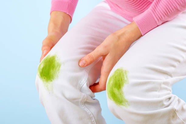 istock Female’s hand showing dirty grass stain on white clothes 1601179220