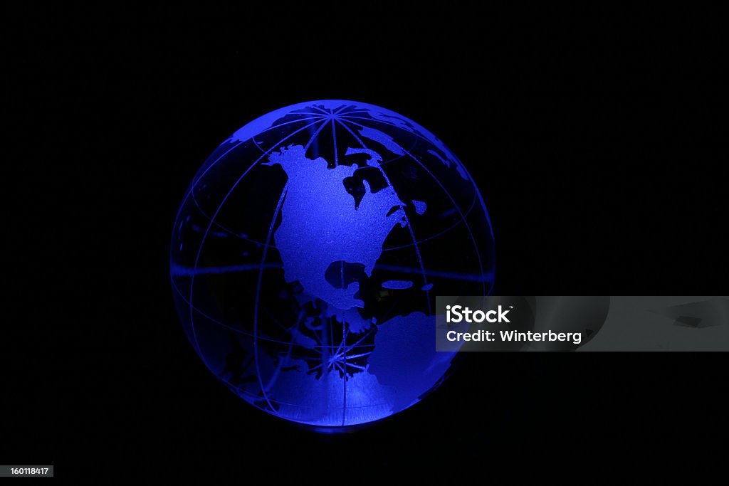 Globe in blue light Planet earth as crystal ball in blue light. Blue Stock Photo