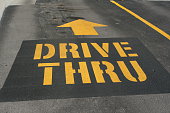 DRIVE THRU with arrow painted on a driveway