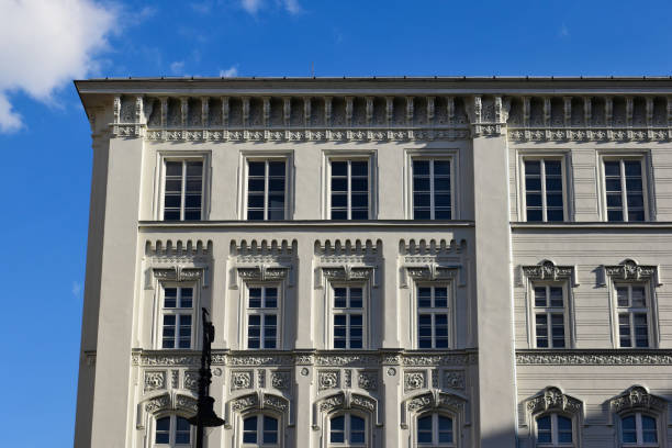 istock white wood windows in classic old exterior elevation with decorative trims. 1601186178