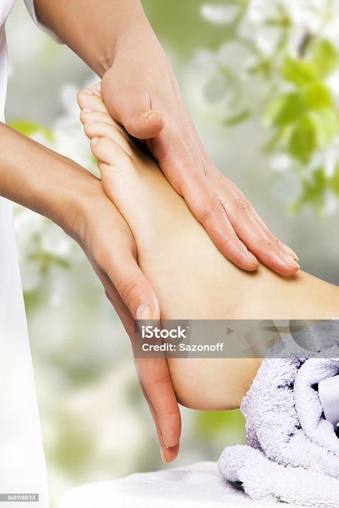 Foot massage in the spa salon Reflexology Stock Photo