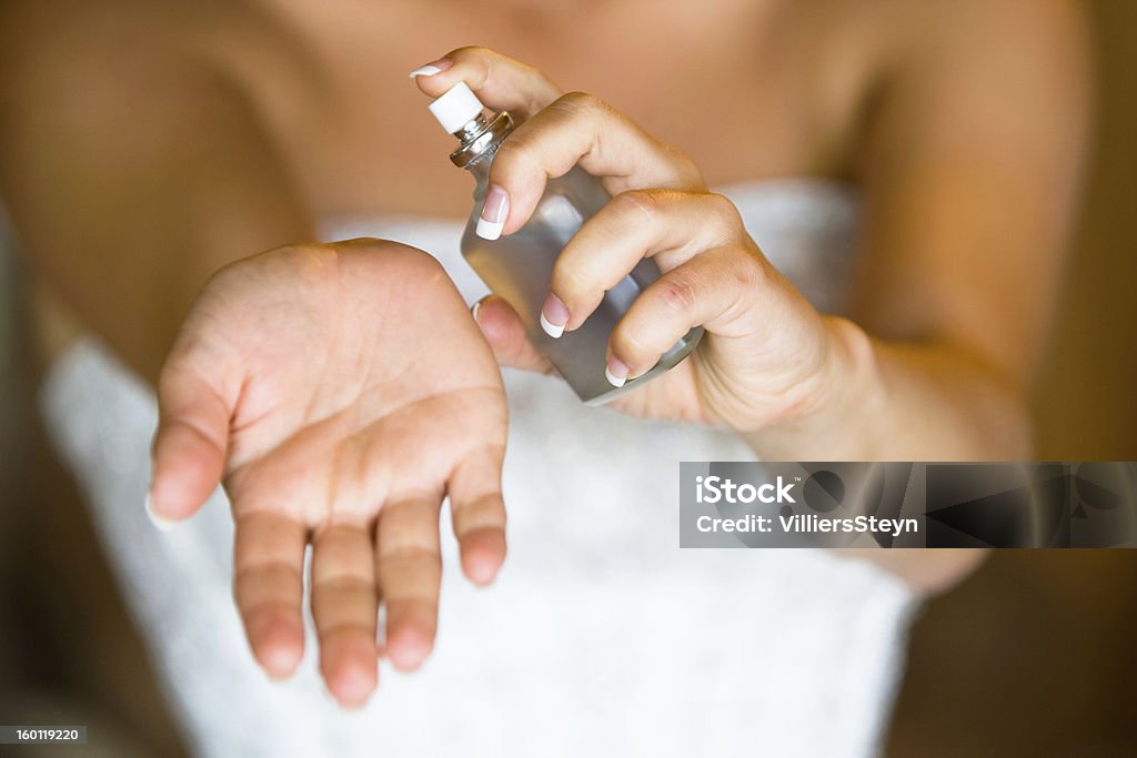 Bride spraying perfume A woman spraying perfume on her wrist Adult Stock Photo