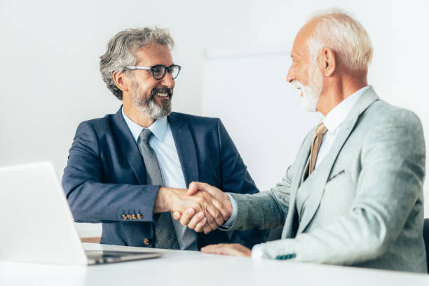 istock Businessmen handshake in the office 1601193982
