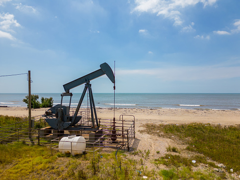 Photo of an old oil pumpjack on High Island Beach Texas