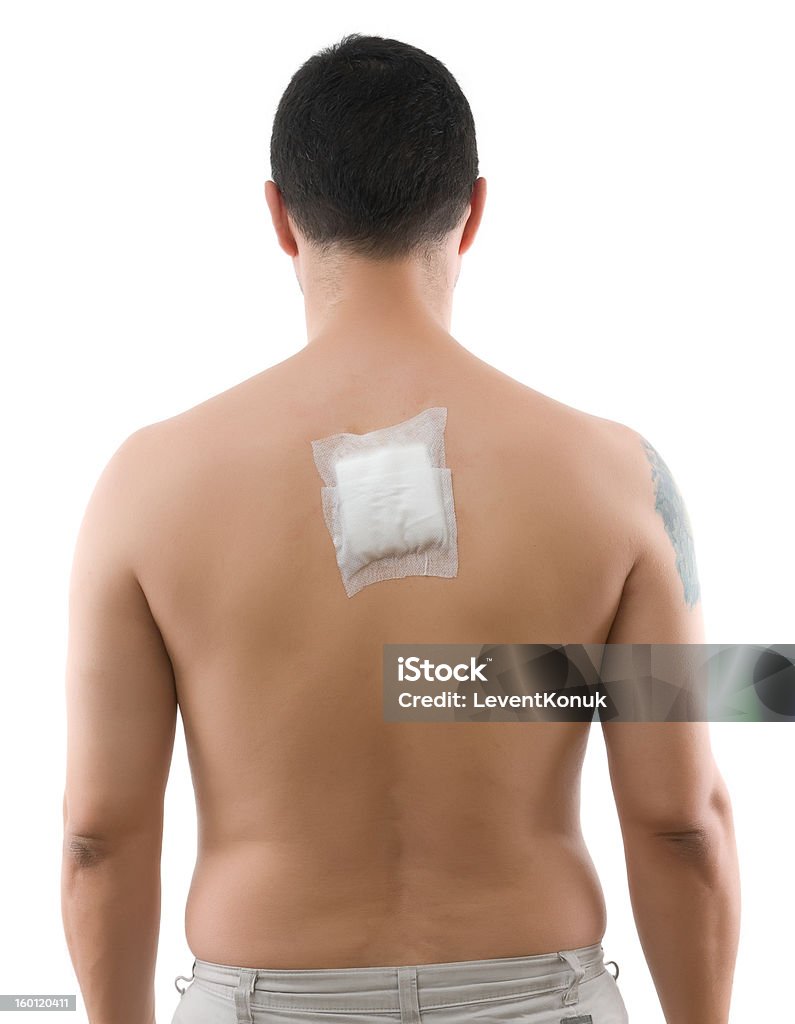 After Surgery Band aid plaster covering back of an adult man. 30-39 Years Stock Photo