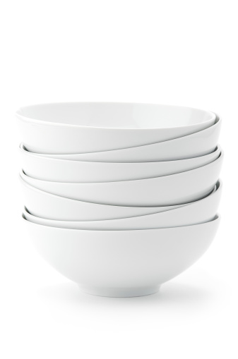 Stack of white bowls in seamless white background.