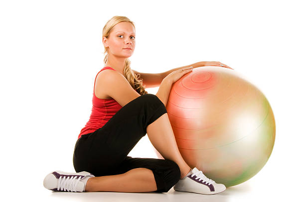 istock Blond woman exercising with a pilates ball 160121262