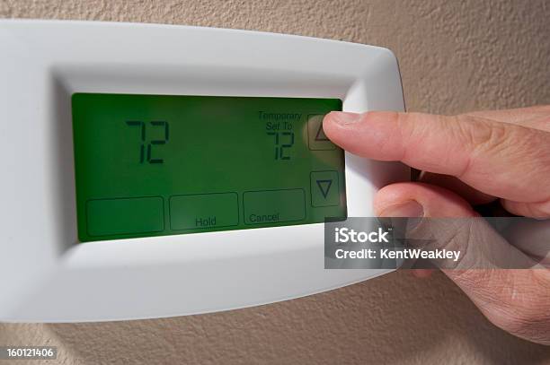 Changing The Temperature On A Digital Thermostat Stock Photo - Download Image Now - Thermostat, Adjusting, Climate
