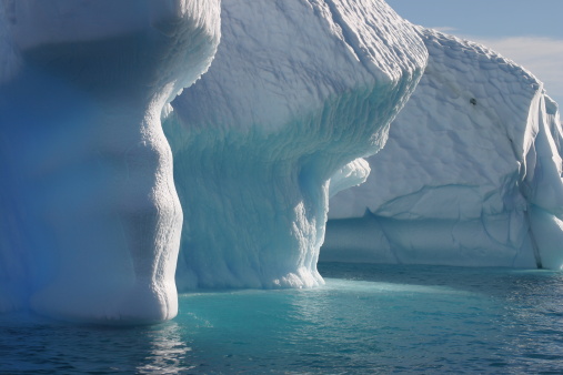 Illuminated Iceberg in Antarctica seen from a sailing boat