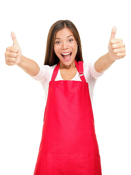 Happy small business owner excited in red apron showing thumbs up success sign isolated on white background. See more:
