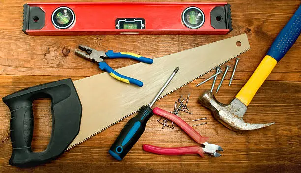 Carpenter's toolkit on wooden board