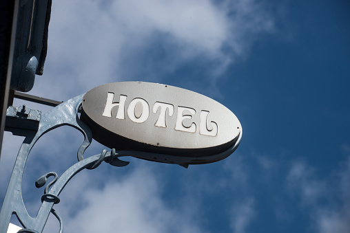 Closeup of hotel sign on blue sky background
