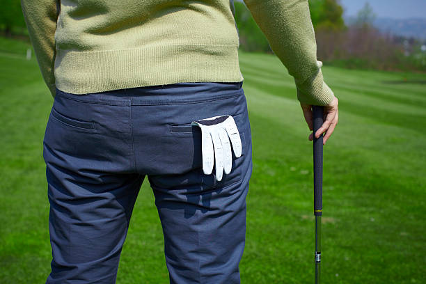 Golfer from the back with glove and golf club stock photo