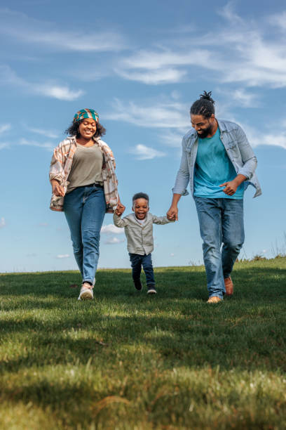 istock Joyful parents with small son outside. 1601232958