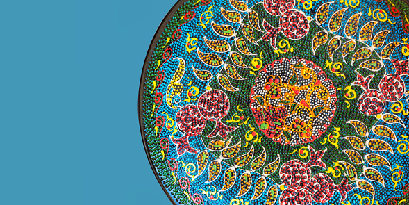Classical traditional uzbek ceramics, handmade colorful dish. Isolated, solid color background, banner, copy space. Tashkent, Uzbekistan